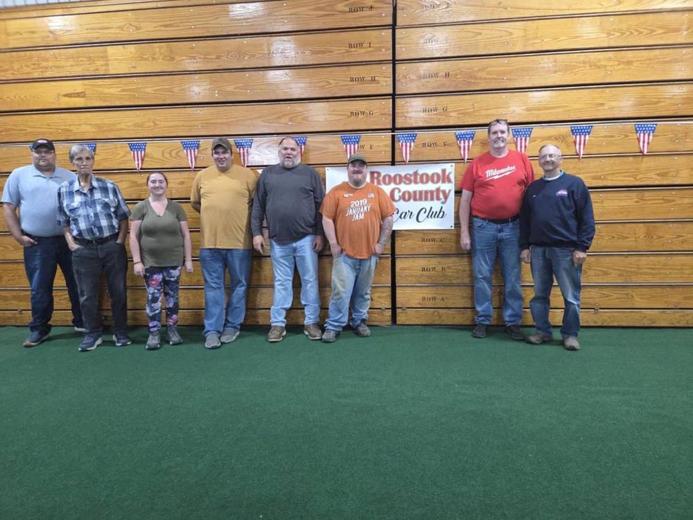 Club members posing in front of the RCCC banner